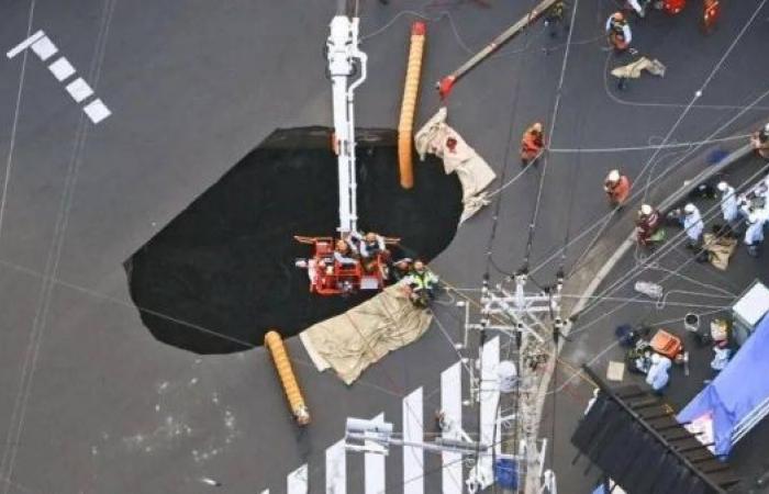 Rescuers race to pull out truck driver stuck in Japan sinkhole for three days