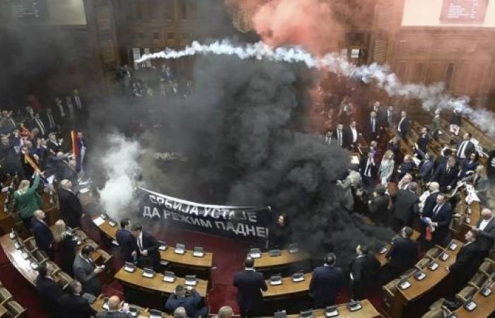 Serbia's parliament erupts into chaos as opposition MPs set off flares and smoke grenades