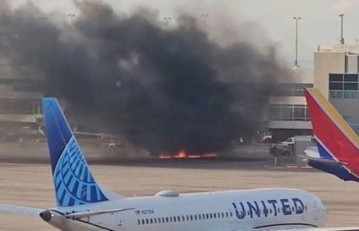 Passengers evacuate onto wing of burning American Airlines jet