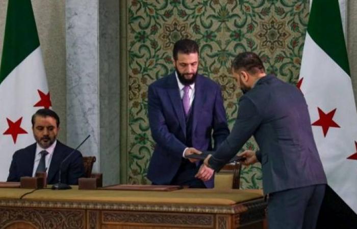 Syria's president signs temporary constitution amid ongoing conflict