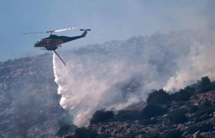 Firefighting helicopter crashes into sea trying to collect water as wildfires burn across Greece