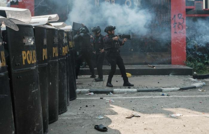 Indonesian police fire tear gas at protesters demanding justice for driver run over by tactical vehicle