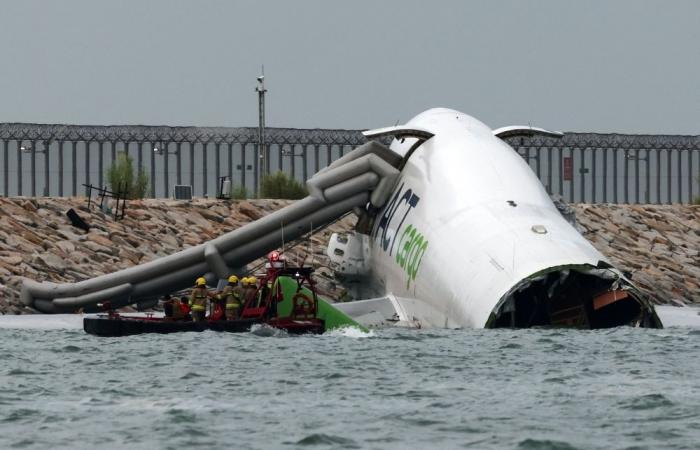 Cargo plane skids off runway into sea at Hong Kong airport, killing two in patrol vehicle, flights unaffected