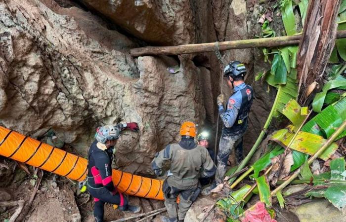 Laos cave rescue: Four men carried out on stretchers, two remain missing after flash floods