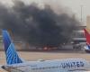 Passengers evacuate onto wing of burning American Airlines jet